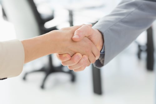 Close-up of shaking hands after a business meeting in the office
